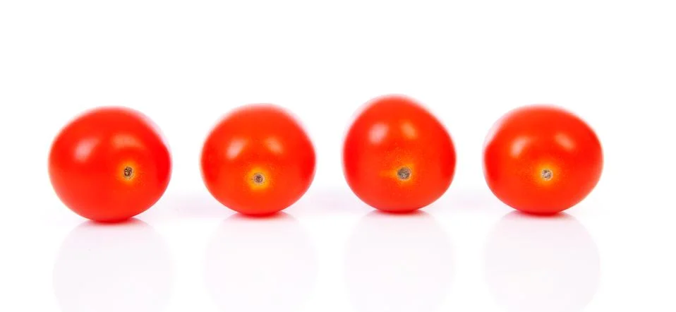 Four cherry tomatoes in a row Stock Photos