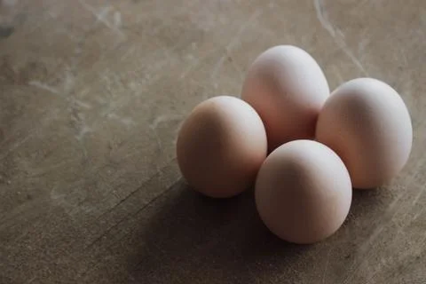 Four chicken organic eggs on rustic wooden background. Spring raw fresh style Foto stock