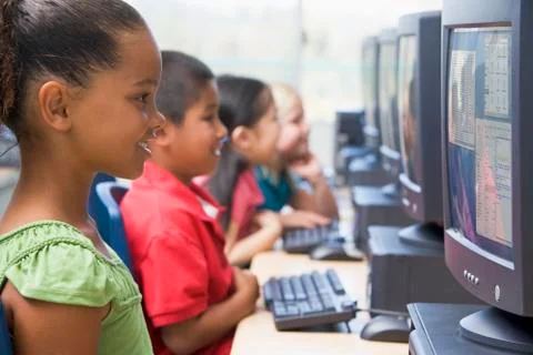 Four children at computer terminals (depth of focus/high key) Stock Photos