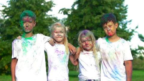 Four children standing in front of the camera and smiling in delight 스톡 동영상 70878410