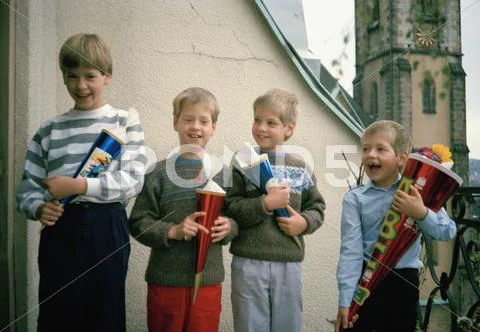 Four children standing in a row Stock Photos