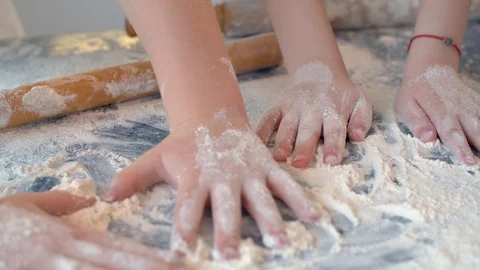 Four children's hands playing with flour Stock Footage 124943068
