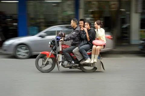 Four chinese persons riding motorcycle Stock Photos
