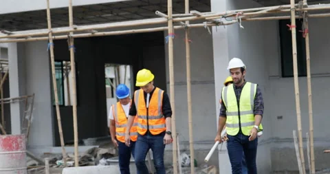 Four civil engineers leave the building. Stock Footage 195615414