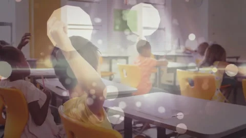 Four classmates raising hands after teacher asking question in classroom with 库存影片 312297983
