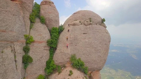 Four climbers climbing the wall on Mount Montserrat Stock Footage 129562853