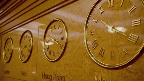 Four clocks on wall show time of London, Paris, Hong Kong and Moscow Video stock 74454689