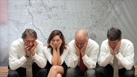 Four Colleagues sitting in a row waiting nervously. Stockbeeldmateriaal 88407199