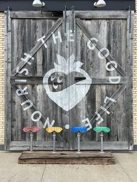 Four Color Stools on the front of the barn door sign Stock Photos