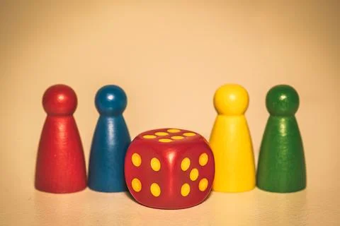 Four colored chips and red dice closeup Stock Photos