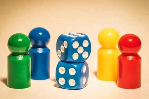 Four colored dices and two dices on the desk Stock Photos