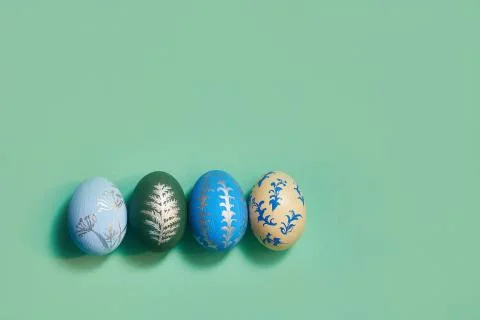 Four colored easter eggs on a green background top view. copy space 库存照片