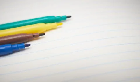 Four colored markers on a white Notepad background, close-up, copy space. pla Stock Photos
