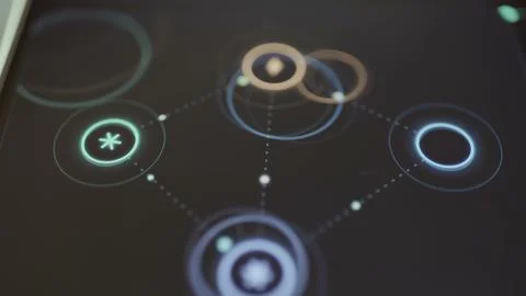 Four connected circular nodes pulse with orbiting rings and moving Stock Photos