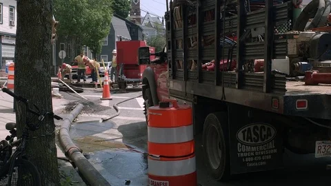 Four Construction Site Workers Inspecting A Large Sink Hole At Residential Stree Stock Footage 76768188