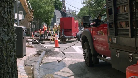 Four Construction Site Workers Inspecting A Large Sink Hole At Residential Stree Stock Footage 76768464