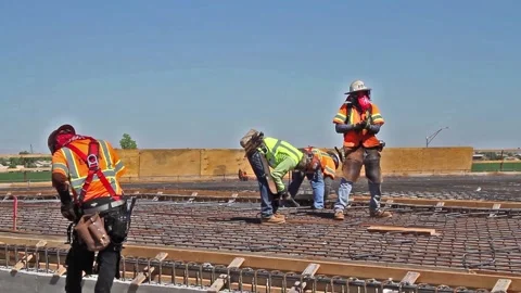Four construction workers in full PPE tying rebar at bridge construction Video stock 151224943