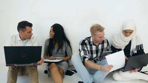 Four creative young modern mixed race office coworkers of men and women which Stock Footage 121843526