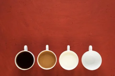 Four cups on red background Stock Photos
