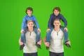 The four cute brothers stand on the green background Photo