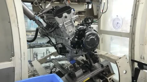 Four cylinder motorcycle engine on assembly line stand Stock Footage 348171201