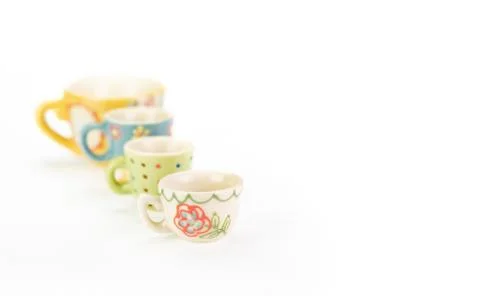 Four decorative ceramic teacups in a row. Copy space. Foto stock