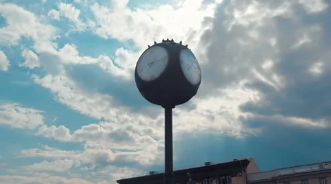 Four dial street clock and moving clouds on a blue sky in time lapse Видео 68352077