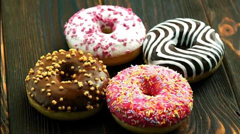 Four different donuts on one plate Stock Photos