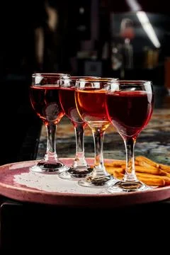 Four different drinks are arranged on a plate. Stock Photos