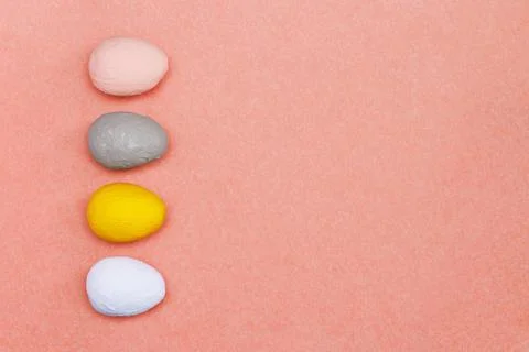 Four different hand-painted eggs on a bright red background. Stock Photos