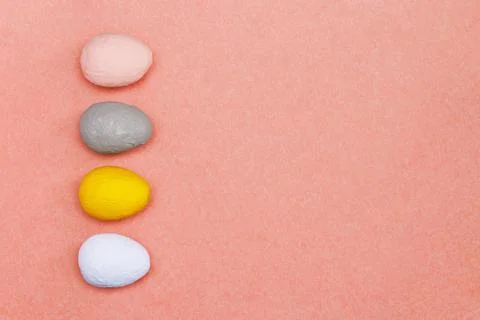 Four different hand-painted eggs on a bright red background. Stock Photos