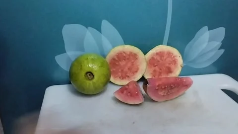 Four different pieces of red crystal guava Stock Footage 229255961