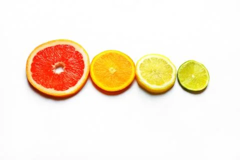 Four different sized slices of citrus fruits Stock Photos