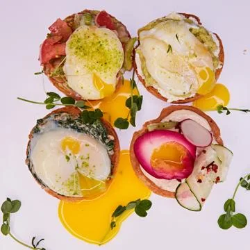 Four different toasts with poached egg. 스톡 사진