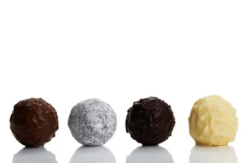 Four different truffles in a row Stock Photos