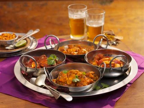 Four different types of curries on a tray Stock Photos