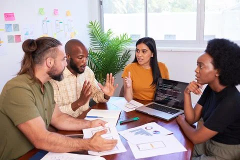 Four diverse developers argue during code review, deadline pressure 写真素材
