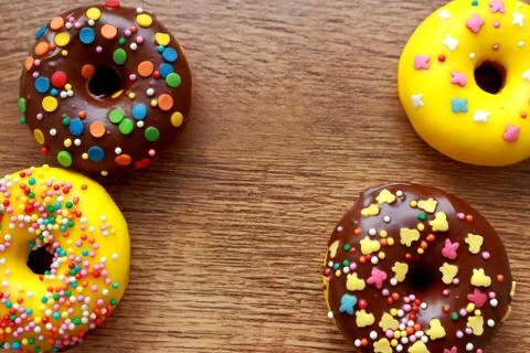 Four donuts composition on a wood background Stock Photos