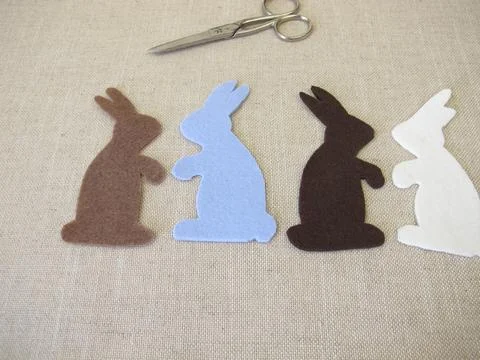 Four Easter bunnies cut out of colored felt Stock Photos