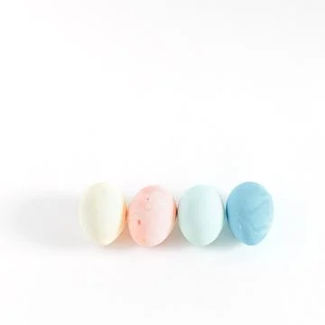 Four easter colored eggs on white background Stock Photos