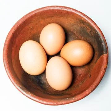 Four eggs in a bowl Stock Photos