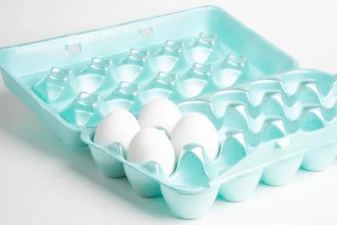 Four Eggs On A Styrofoam Tray Stock Photos