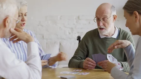 Four elderly people playing cards 스톡 동영상 117505232