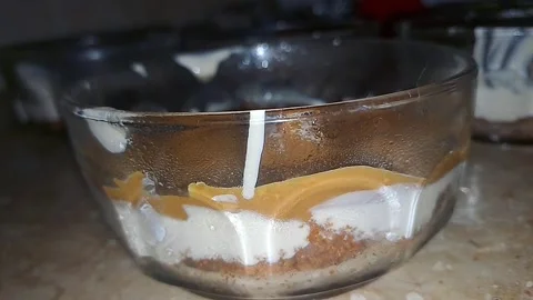 Four elegant mirror bowls filled with colorful sundae desserts Stock Footage 317030417