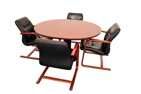Four empty leather office chairs sit around a round table. On a white clipping Stock Photos