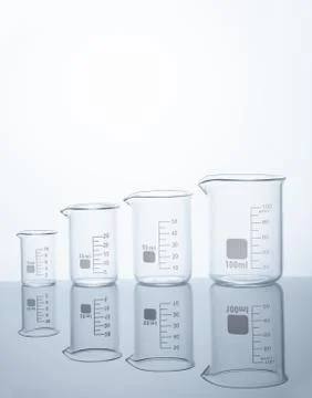 Four empty measuring beakers Stock Photos