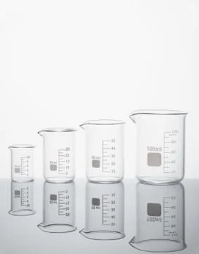 Four empty measuring beakers Stock Photos