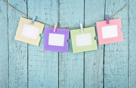 Four empty photo frames hanging with clothespins Stock Photos