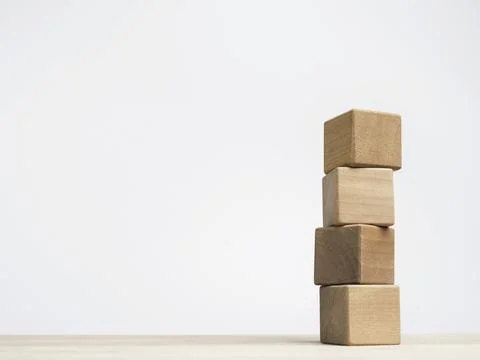 Four empty wooden cube blocks stack on the table on white background with cop Stock Photos