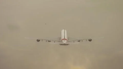 Four engine airliner taking off into cloudy sky with minimal visibility and Stock Footage 311450577